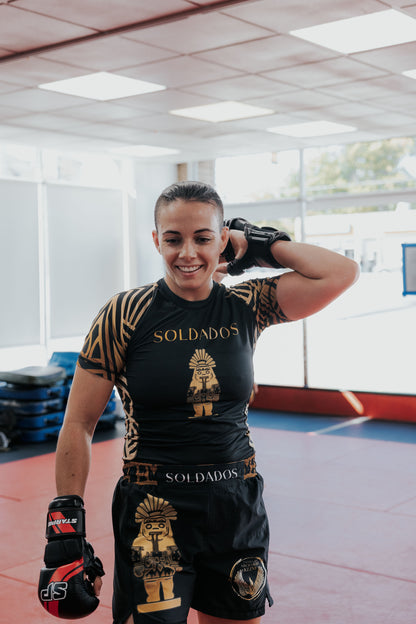 <img src="soldados-womens-mma-grappling-shorts.jpg" alt="Fatima Kline wearing Mens MMA and Grappling Shorts by Soldados Coffee x ILSV Apparel Co.">